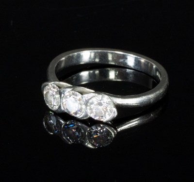 Lot 308 - A diamond three-stone ring set within a...