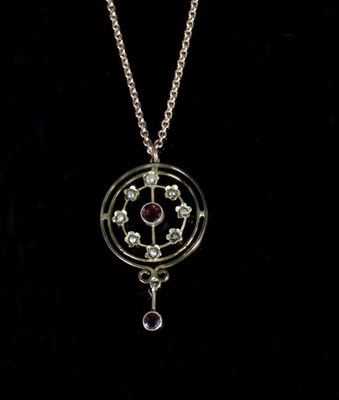 Lot 329 - A ruby and seed pearl pendant of circular...