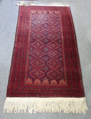 Lot 566 - An Eastern rug, the field of trellis design...