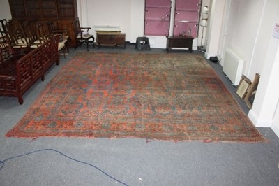 Lot 570 - A large Turkey carpet with stylised motifs in...