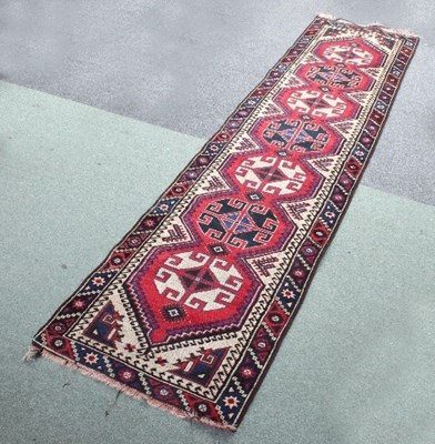 Lot 574 - An Eastern runner of geometric design, 295cm x...