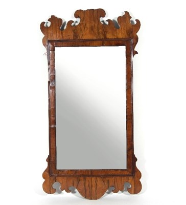 Lot 583 - A George III walnut fret carved mirror, the...