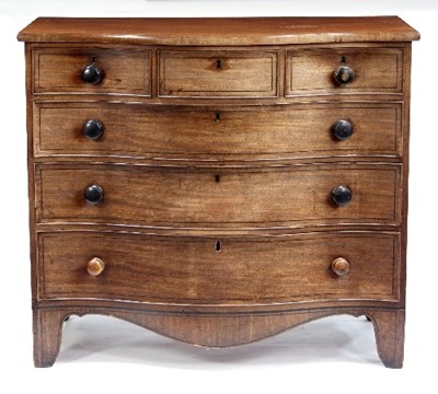 Lot 586 - A Regency mahogany serpentine chest of three...