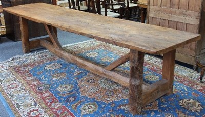 Lot 600 - A rustic fruitwood refectory style table on...