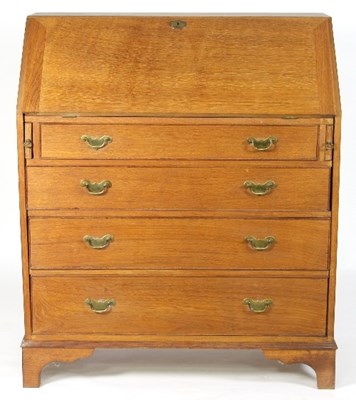 Lot 639 - An oak bureau of George III design, fitted...