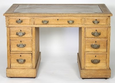 Lot 646 - An oak kneehole desk, fitted a surround of...