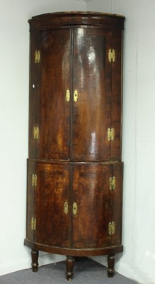 Lot 659 - A George III walnut bowfront corner cupboard,...