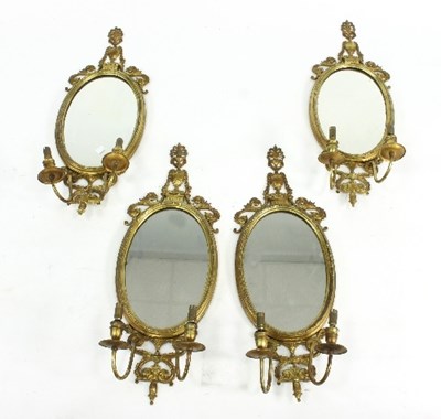 Lot 678 - Four oval gilt metal wall mirrors each with...