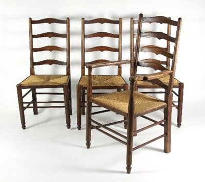 Lot 692 - Four ladder back chairs with rush seats,...