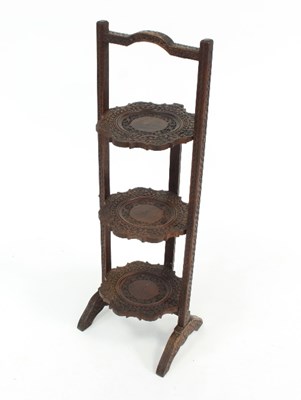 Lot 699 - An Anglo-Indian carved three-tier folding cake...