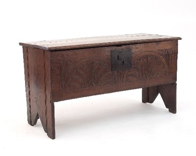 Lot 703 - An oak coffer, with floral scroll carved front,...