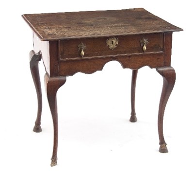 Lot 709 - A George III oak lowboy with crossbanded three-...