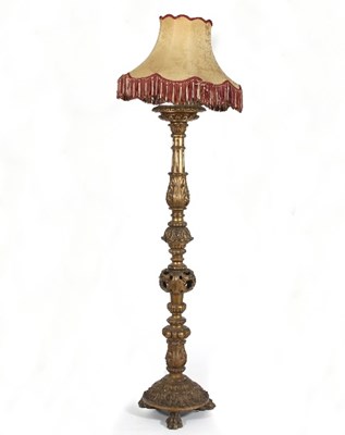 Lot 730 - A carved gilt wood standard lamp on paw feet...