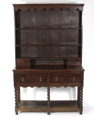 Lot 757 - An oak dresser, the closed rack above two...