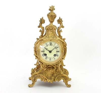 Lot 820 - A gilt metal eight-day mantel clock in a...