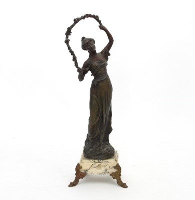 Lot 833 - A spelter figure of a young woman holding a...