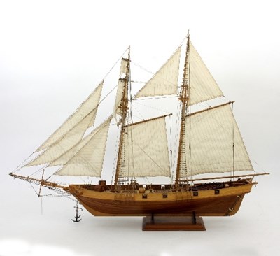 Lot 834 - A wooden model of a tall ship with cloth sails...