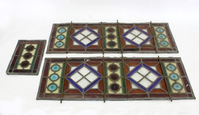 Lot 861 - Three Arts & Crafts stained glass panels, the...