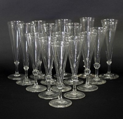 Lot 17 - Fifteen glass flutes, with knopped stems