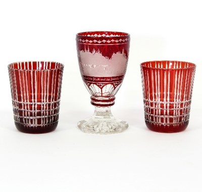 Lot 27 - A Bohemian red glass goblet, engraved a...