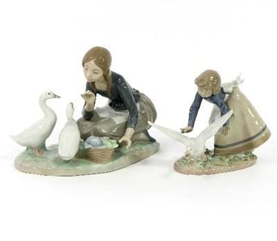 Lot 33 - Two Lladro figures, Feeding Geese, 18cm high...