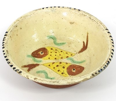 Lot 46 - A circular slipware dish incised two fish and...