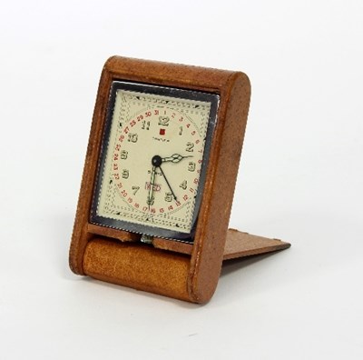 Lot 104 - A Cartier bedside clock, the dial with date...