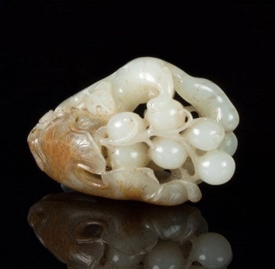 Lot 115 - A Chinese white and russet jade pendant carved...