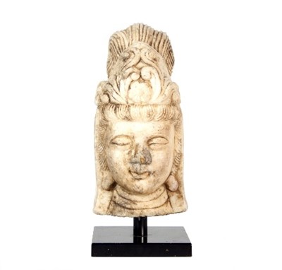 Lot 121 - A carved marble head of Guanyin, on a metal...