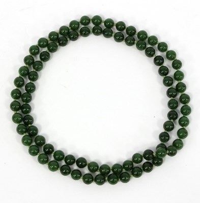 Lot 205 - A single row of spinach jade beads/Note:...