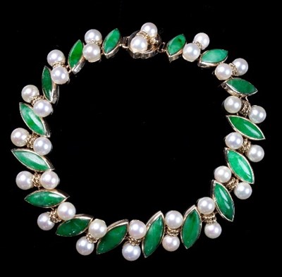 Lot 207 - A jade and pearl bracelet, set in 14K gold,...