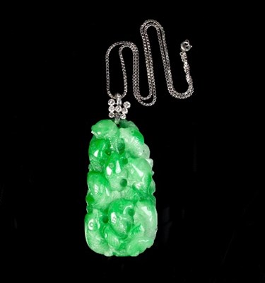 Lot 208 - A carved jadeite pendant modelled as a shoal...