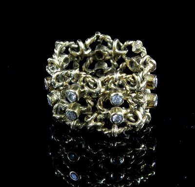 Lot 218 - A gold and diamond articulated ring, the seven...