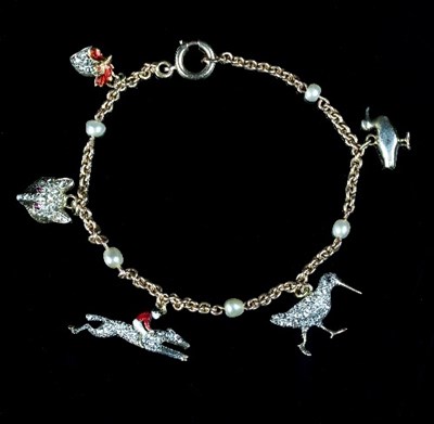 Lot 222 - A gold charm bracelet of sporting interest,...