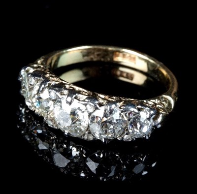 Lot 226 - A diamond five-stone ring in a scroll setting...