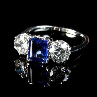 Lot 228 - A sapphire and diamond three-stone ring, the...