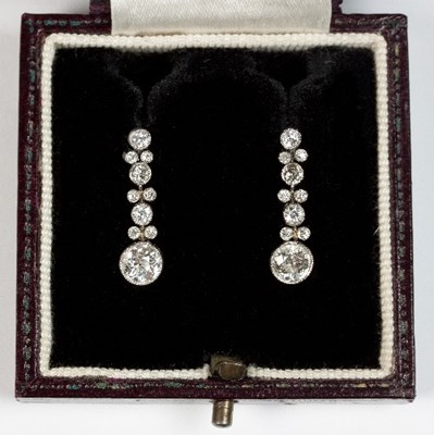 Lot 239 - A pair of diamond drop earrings, each with a...