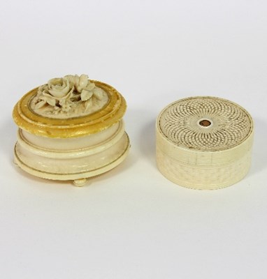 Lot 257 - A circular ivory box with spiral and plaited...