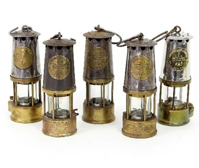 Lot 326 - Four miners lamps by The Protector Lamp and...