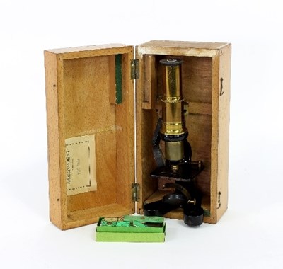 Lot 340 - A small microscope in a fitted case with...