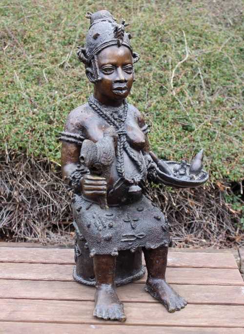 Lot 366 - A Nigerian tribal bronze depicting a seated...