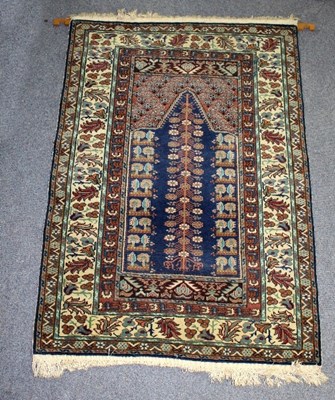 Lot 402 - A modern Eastern rug decorated in blues and...