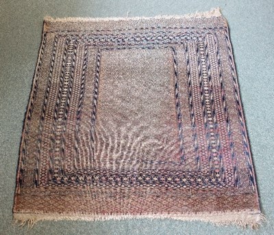 Lot 411 - A Turmenistan rug of red ground and...