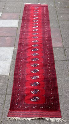 Lot 417 - An Afghan runner, 590cm x 84cm