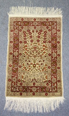 Lot 423 - A modern Persian silk carpet of floral design,...