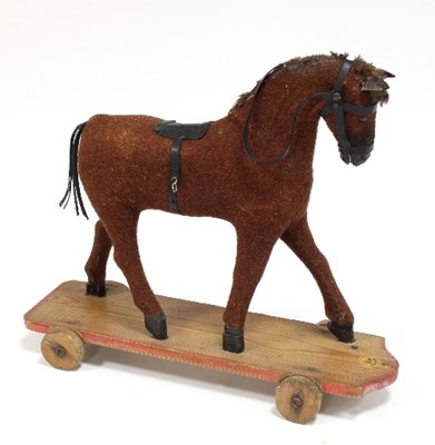 Lot 439 - A child's pull-along horse, mounted on board...