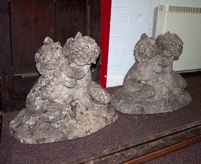 Lot 456 - A pair of reconstituted stone garden statues...