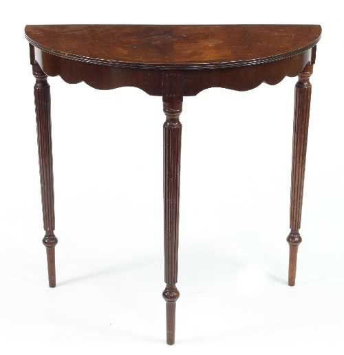 Lot 486 - A Mahogany half-round table, with shaped apron...