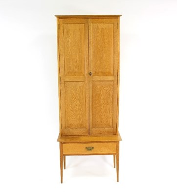 Lot 530 - A modern oak gun cabinet, 127cm high and a...