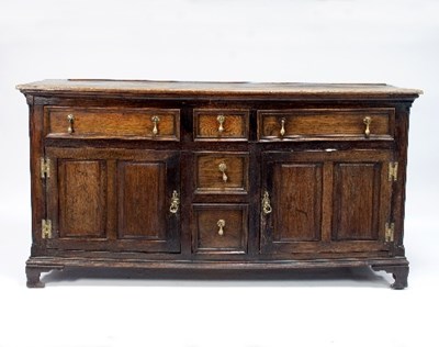 Lot 551 - An oak dresser fitted drawers and cupboards,...